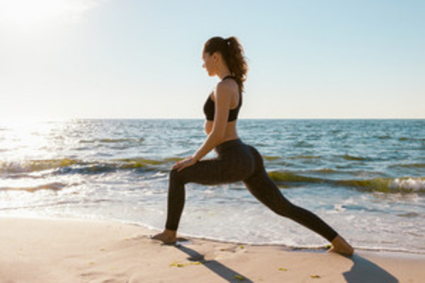 girl on beach exercising, lunges, weight gain